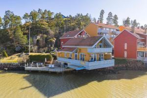 a large house on a dock in the water at Waterfront Home-Tonsberg in Tønsberg