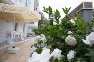 an umbrella and some white flowers on a balcony at Ada Apart Hotel in Antalya