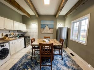 a kitchen with a table with chairs and a refrigerator at Lakefront Suite with Geodesic Dome Experience in Stouffville