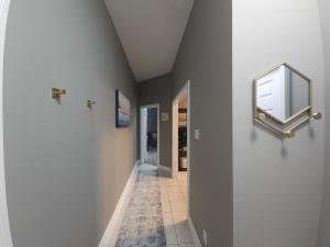 a hallway with a mirror and a tile floor at Lakefront Suite with Geodesic Dome Experience in Stouffville