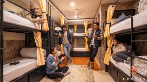 a group of people are standing inside of a bus at Zostel McLeodganj in McLeod Ganj
