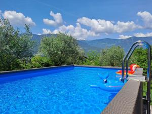 a swimming pool with a view of mountains at Penthouse & Garden - luxury apartment in Postal