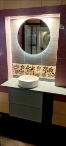 a bathroom with a sink and a mirror at Dom na wynajem Pasym in Pasym +31 photos