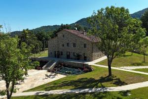 an aerial view of a stone house with trees at Agriturismo Bramalpane in Bagno di Romagna
