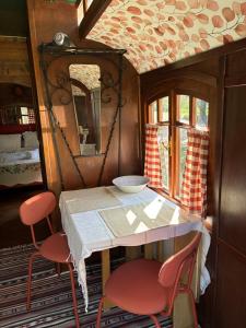 a room with a table and two chairs and a mirror at Idyllic Roulotte in Les Assions