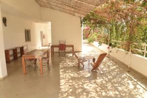 a dining room with a table and chairs and a window at Villa Saraba in Somone