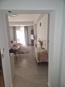a hallway of a living room with a table at Liliana's house in Kallithea Halkidikis
