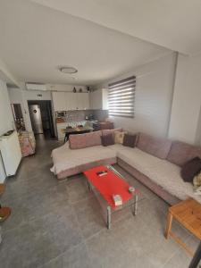 a living room with a couch and a table at Liliana's house in Kallithea Halkidikis