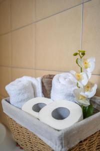 a basket with towels and flowers in a bathroom at Mambo Private Villa with Pool by the Beach in Paralimni +32 photos