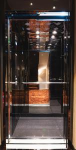 a glass door of a store with a room at Golden Boutique Hotel in Tbilisi City