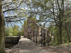 a building in the middle of a park with trees at Lucky Beach in Renesse