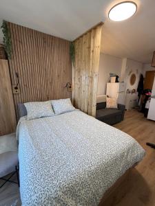 a bedroom with a large bed and a couch at Tamy-Home in Empuriabrava