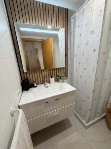 a bathroom with a sink and a mirror at Tamy-Home in Empuriabrava +17 photos