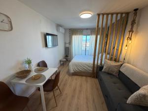 a living room with a couch and a bed at Tamy-Home in Empuriabrava