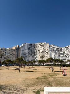 a large apartment building with trees in front of it at Tamy-Home in Empuriabrava