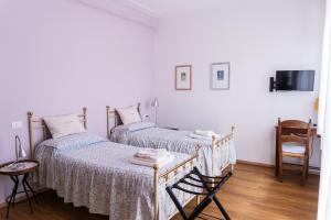 a bedroom with two beds and a chair at Lucignolo in Fucecchio