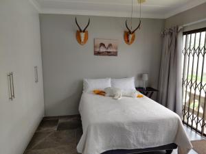 a bedroom with a bed with a stuffed animal on it at GOOSE Nest in Gonubie