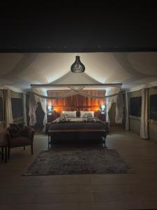 a large bedroom with a bed in a tent at Chamabondo Luxury Tented Camp in Victoria Falls