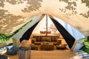 a tent with a couch and a chair in it at WoodMood in Leuk