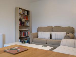 a living room with a couch and a table at Lower Cottage in Orkney