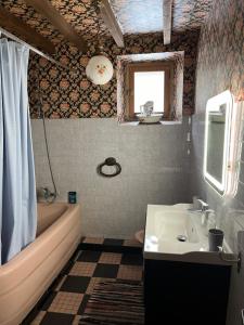 a bathroom with a sink and a tub and a toilet at La Régalade, Pyrénées in Sorgeat