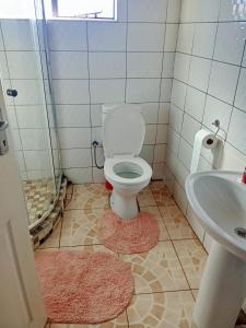 a bathroom with a toilet and a sink at Qbela in Phuthaditjhaba