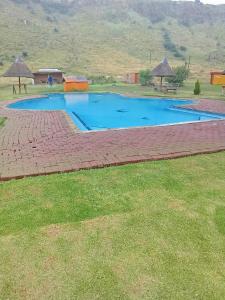 a large swimming pool in a field of grass at Qbela in Phuthaditjhaba +1 photo