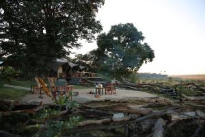 a group of chairs and tables in front of a tent at Chamabondo Luxury Tented Camp in Victoria Falls +15 photos