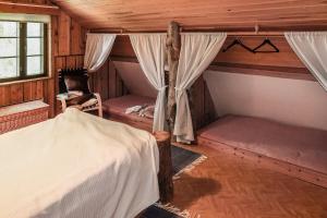 a bedroom with a bed and curtains in a room at Vacation home 'Örtsylä A' in Salla