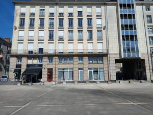 a large building with a large parking lot in front of it at Exclusivité - La Maison à Vapeur avec climatisation in Nantes