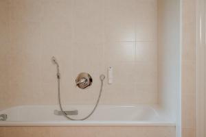 a shower in a bathroom with a bath tub at Das Bergfrieden Nature Active Hotel in Martello +28 photos