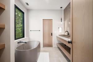 a bathroom with a large tub and a sink at Highpoint in New Plymouth +74 photos