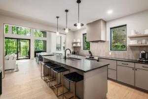 a kitchen with a large island with bar stools at Highpoint in New Plymouth