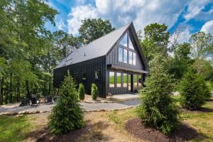 a black house with a gambrel roof at Highpoint in New Plymouth
