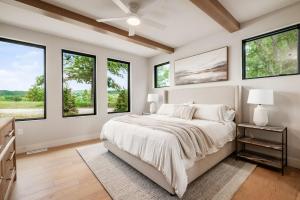 a bedroom with a large bed with windows at Highpoint in New Plymouth