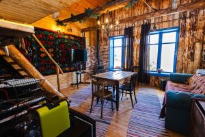 a living room with a table and a couch at Cabana Vatra Plaiului in Şarul Dornei