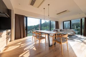 a kitchen and living room with a table and chairs at Intuition in Kutchan