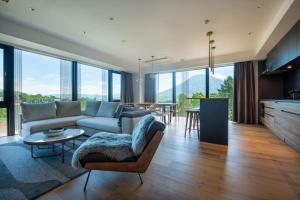 a living room with a couch and a table at Intuition in Kutchan +114 photos