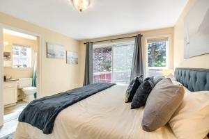 a bedroom with a bed with pillows and a window at Driftwood Hideaway in Indian Beach