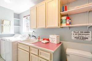 a small kitchen with a sink and a washing machine at Driftwood Hideaway in Indian Beach +31 photos