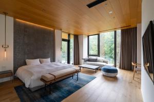 a bedroom with a large bed and a couch at Intuition in Kutchan