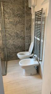 a bathroom with a toilet and a sink at Domus Pioppa in Modena