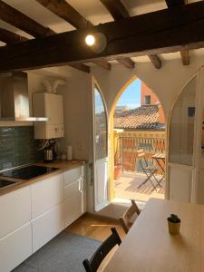 a kitchen with a table and a view of a deck at Domus Pioppa in Modena
