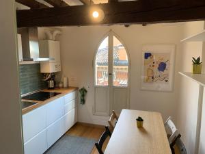 a kitchen with a table and a table and a window at Domus Pioppa in Modena +13 photos