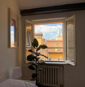 a room with a window with a view of the city at Domus Pioppa in Modena