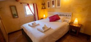 a bedroom with a large white bed with towels on it at Clos du Veyrier in Bédoin +42 photos