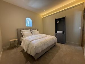 a bedroom with a large bed and a window at DomaineduRocBlanc in Merey