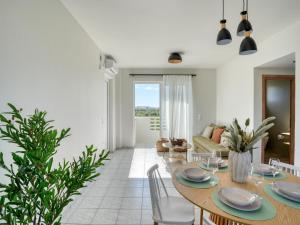a dining room and living room with a table and chairs at Aurelea Luxury Apartments in Kos