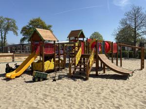 a playground with a slide in the sand at Bondi Beach in Renesse