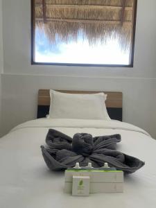 a bed with a pile of towels on it at Isa Pro hostel panglao in Sampong